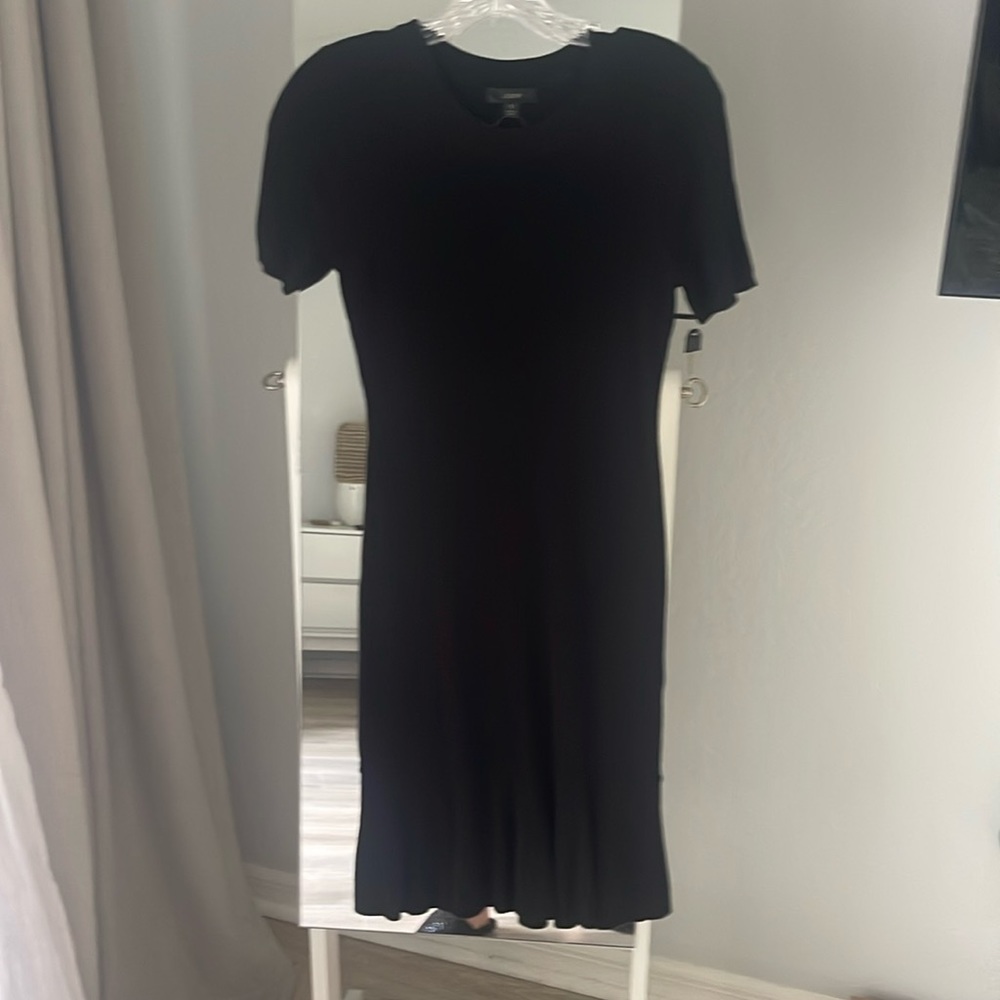 NWT black fitted knit dress with slight ruffle at hem